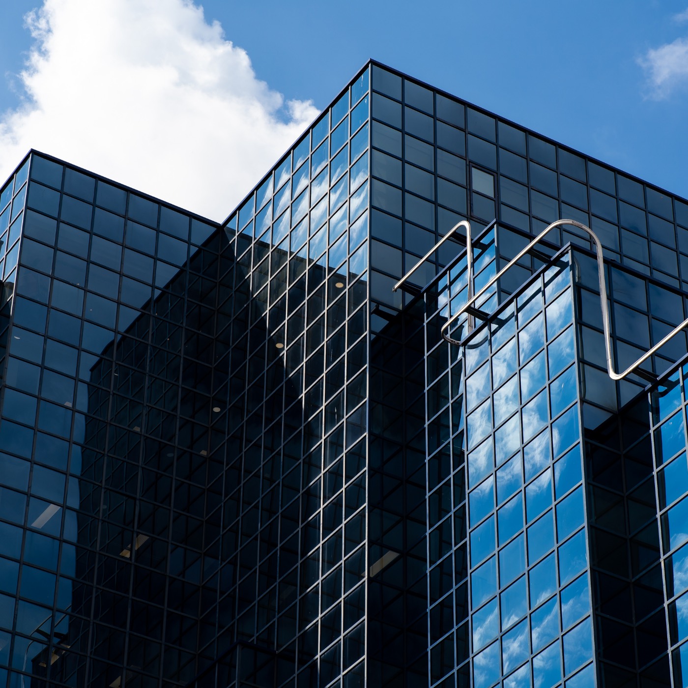 Modern glass facade reflecting the sky