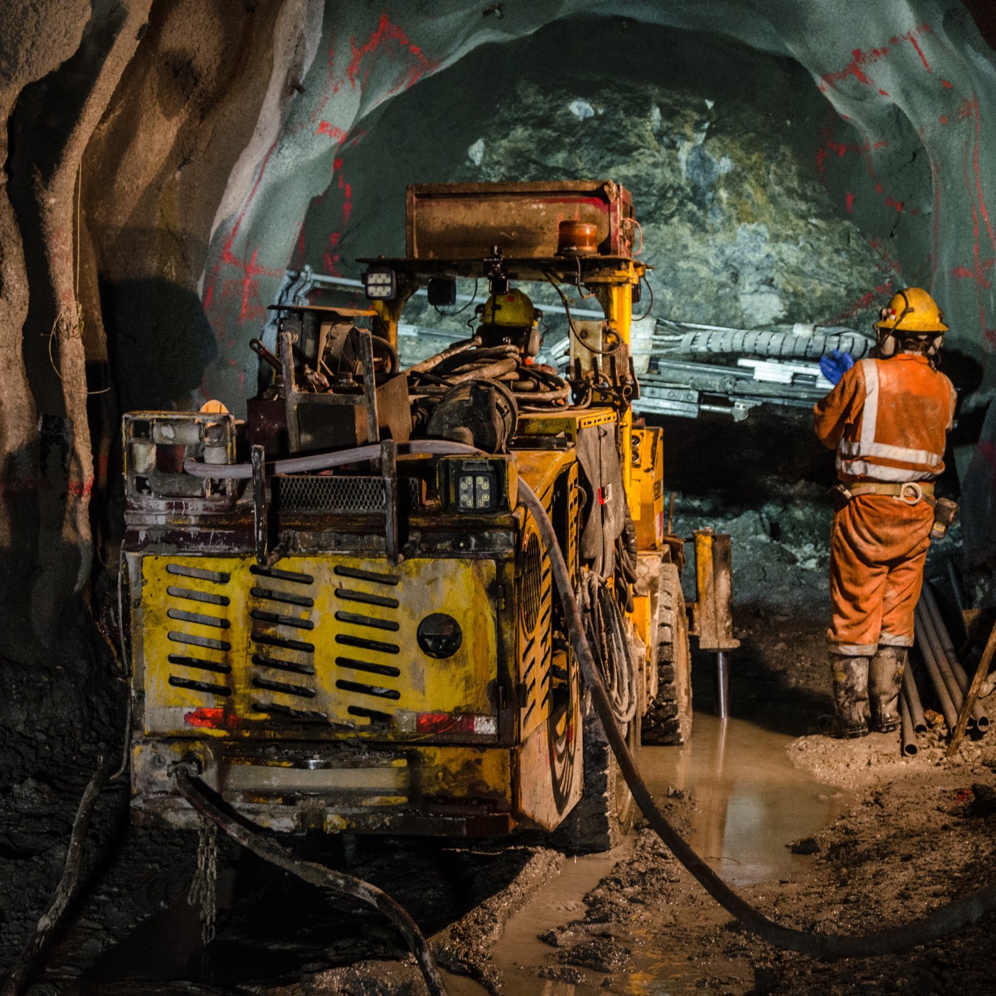 Industrial equipment and worker inside an underground plant area
