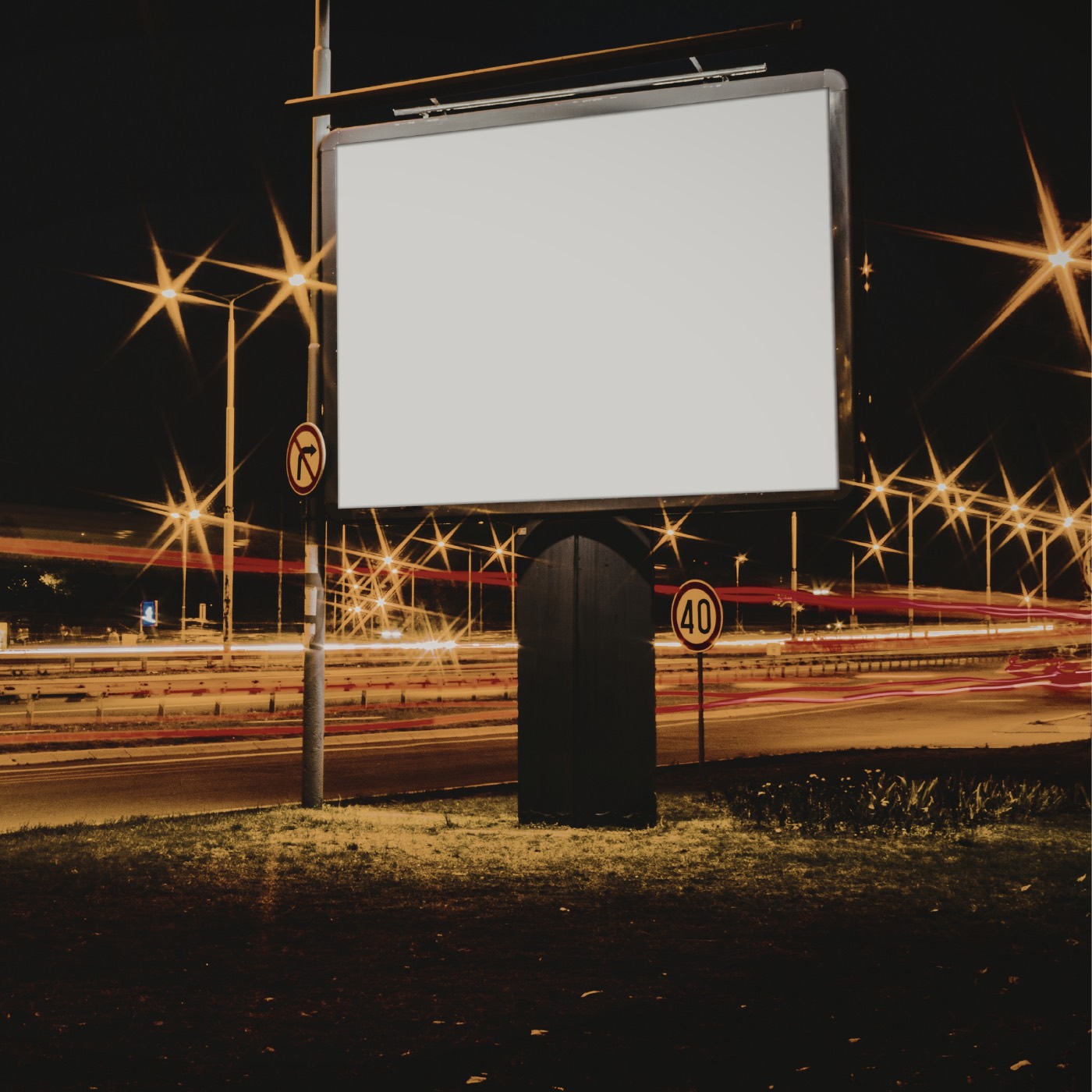 Large roadside billboard structure lit at night